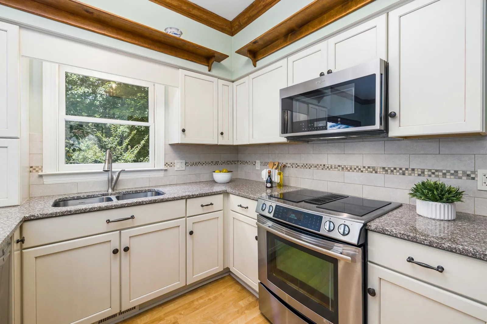 Kitchen renovation in progress, with cabinets in mid-installation and trades work underway