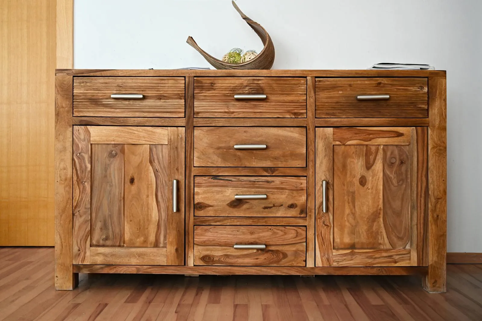 Wood-grain cabinet finish detail showing the kind of natural texture homeowners weigh against painted and laminate options